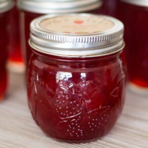 closeup of a canning jar filled with freshly made homemade strawberry jam