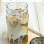 Cold Brewed Iced Coffee in a mason jar with a lid and straw.