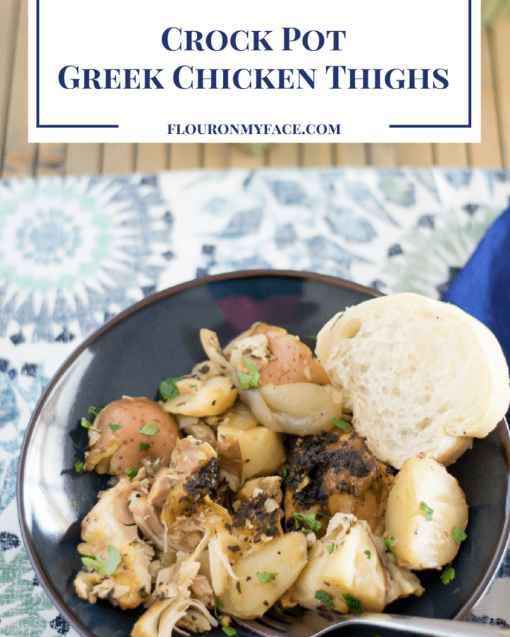 Crock Pot Greek Chicken Thighs served with potatoes on a dinner plate.
