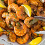 A serving platter piled high with New Orleans Style Barbecue Shrimp