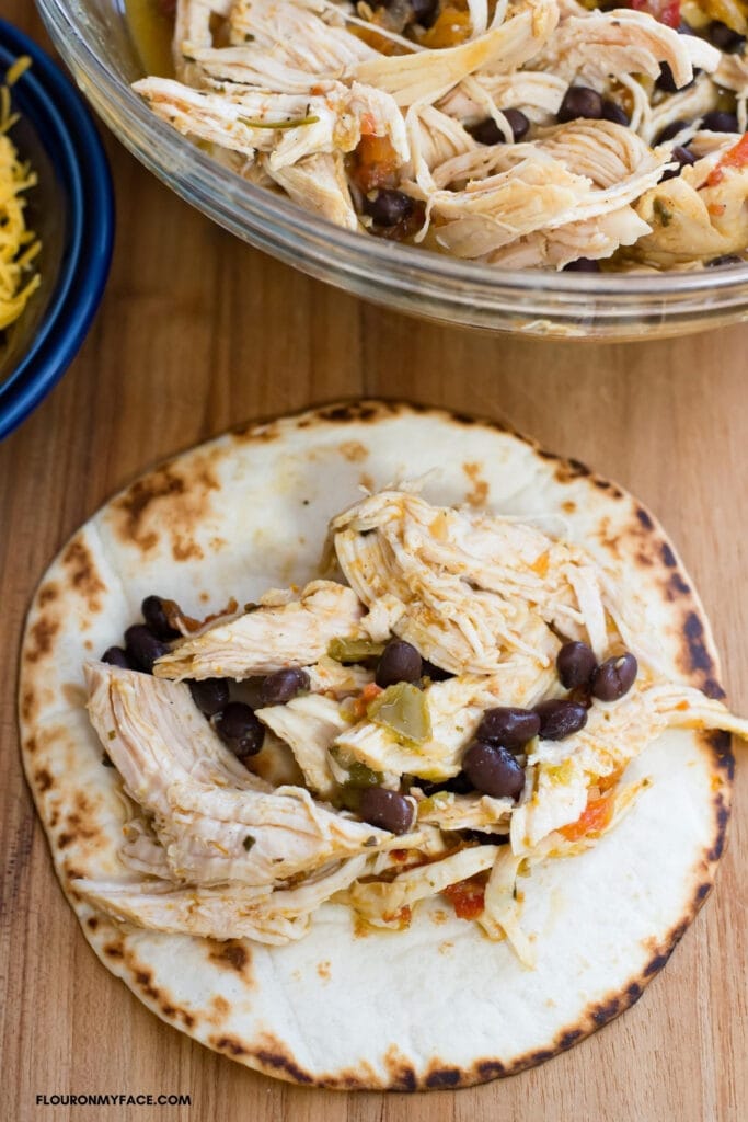 chicken taco filling on a flour tortilla