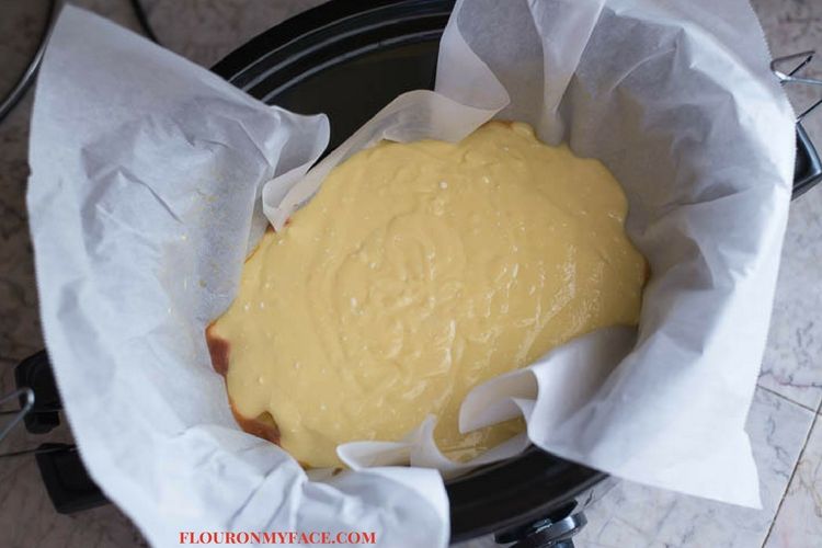 Crock Pot Pineapple Upside Down Cake batter in the parchment paper lined crock pot.