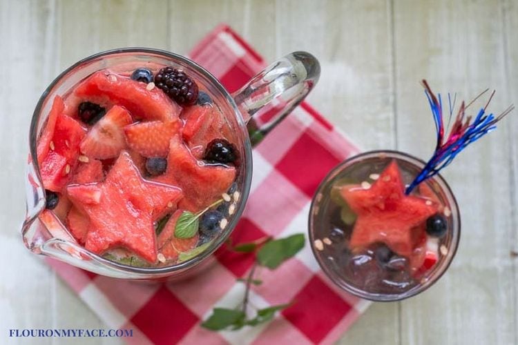Patriotic Red WHite Blue Moscato Sangria recipe in a pitcher with a glass serving via flouronmyface.com