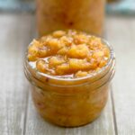 Overflowing canning jar filled with Caribbean Fruit Salsa.