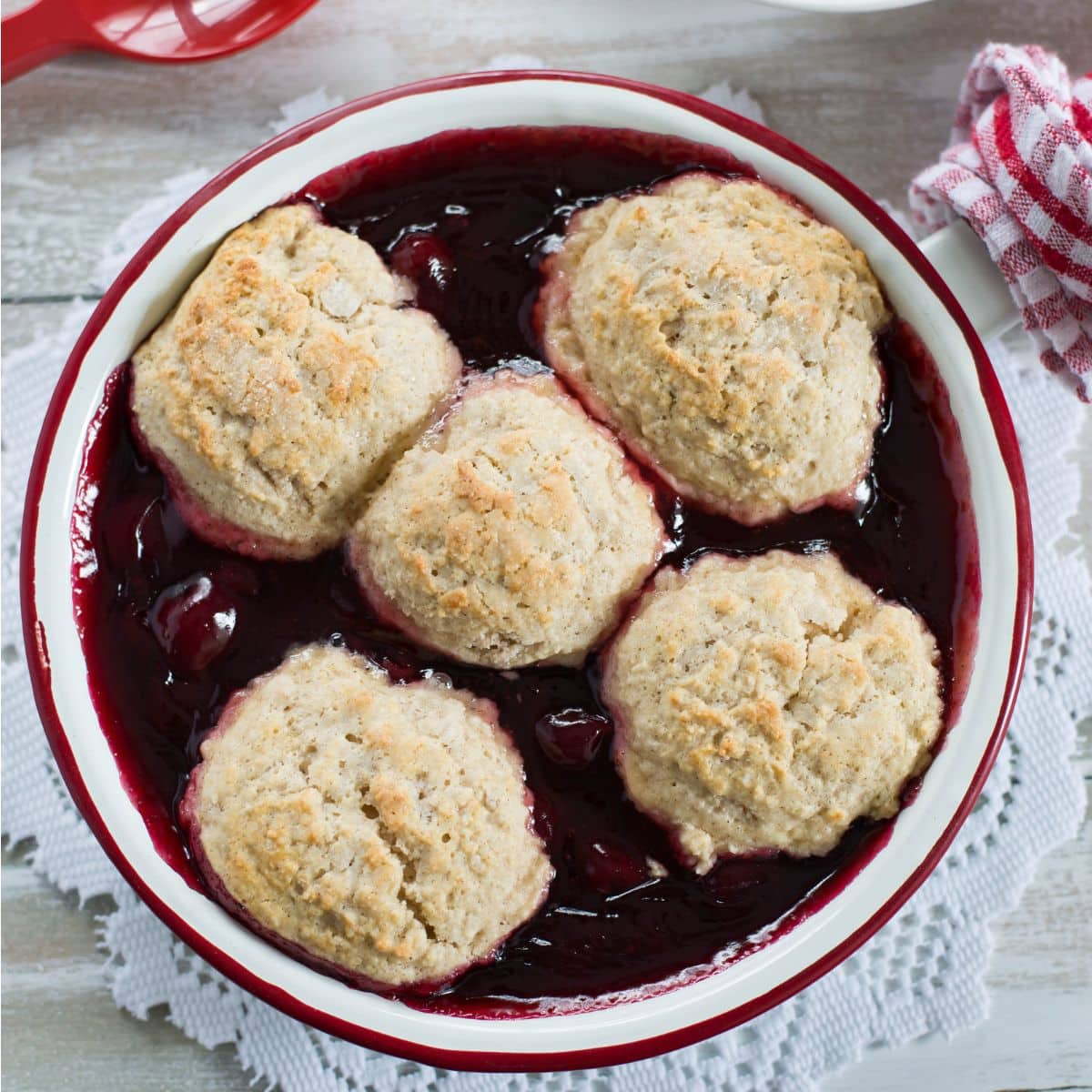 A round pan filled with freshly baked cherry cobbler.