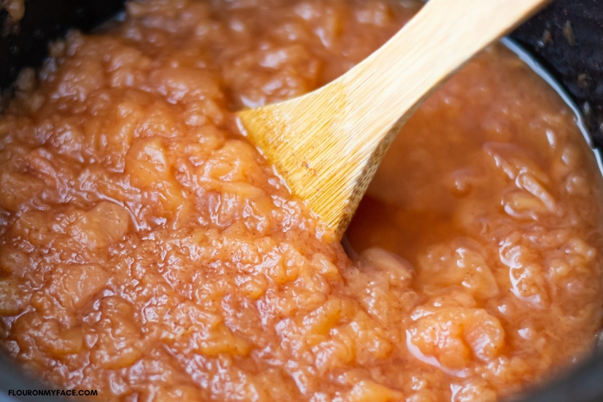 crockpot applesauce as it cooks inside a slow cooker