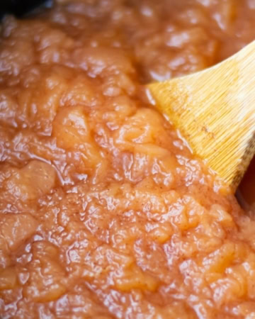 crockpot applesauce as it cooks inside a slow cooker