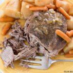 Crock Pot Pot Roast is moist and tender. Served with potatoes and carrots.
