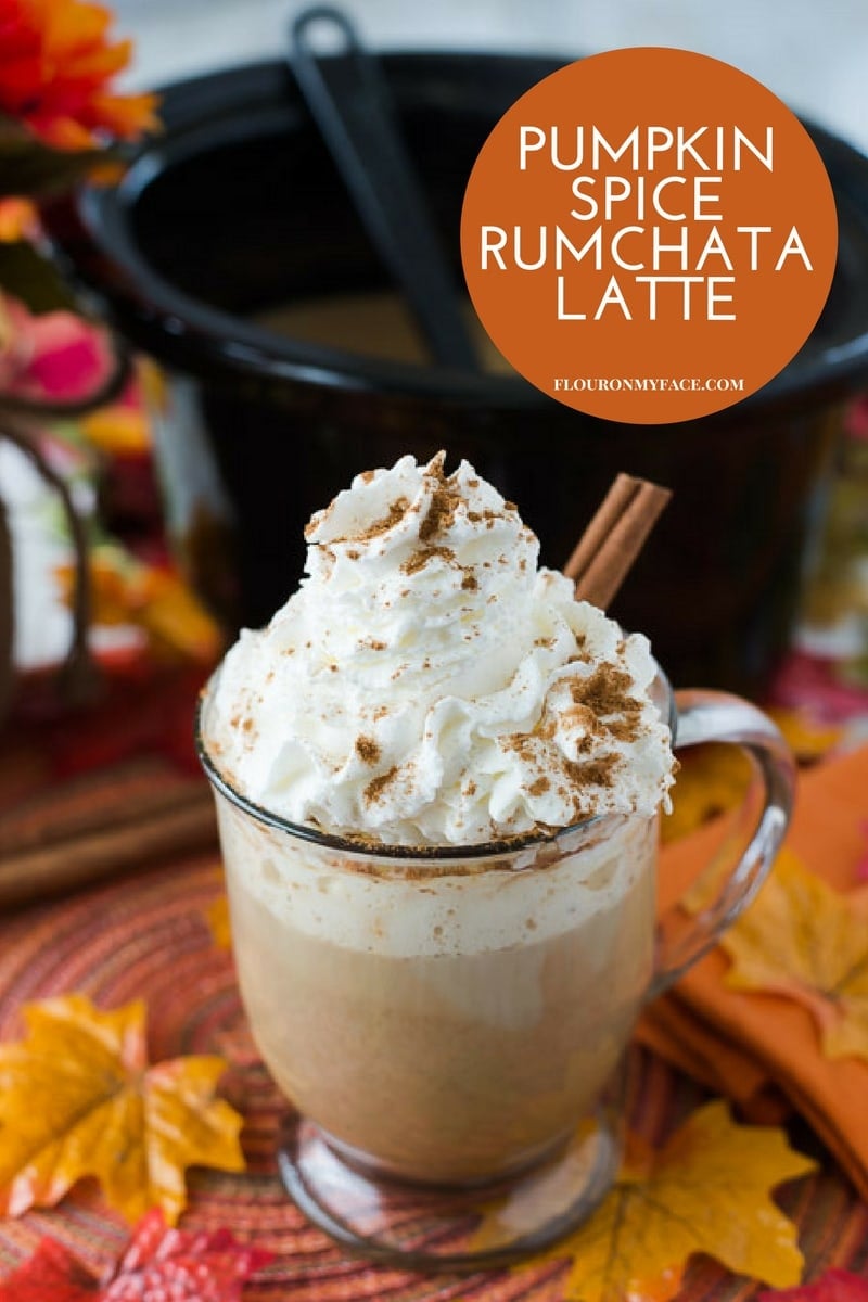 Mug filled with Crock Pot Pumpkin Spice Rum Chata Latte topped with whipped cream.