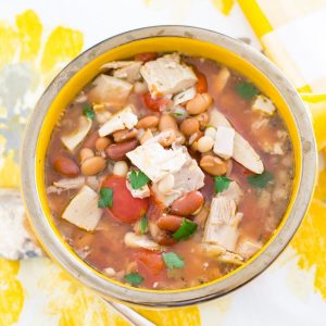 Overhead photo of a soup bowl filled with Three Bean Turkey Soup