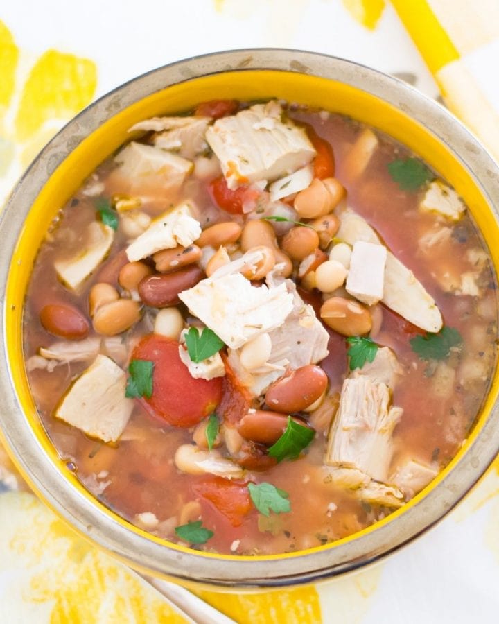 Overhead photo of a soup bowl filled with Three Bean Turkey Soup
