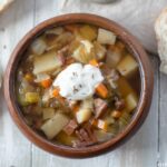 Ham Cabbage Potato and Fennel Soup recipe served in a wooden bowl.
