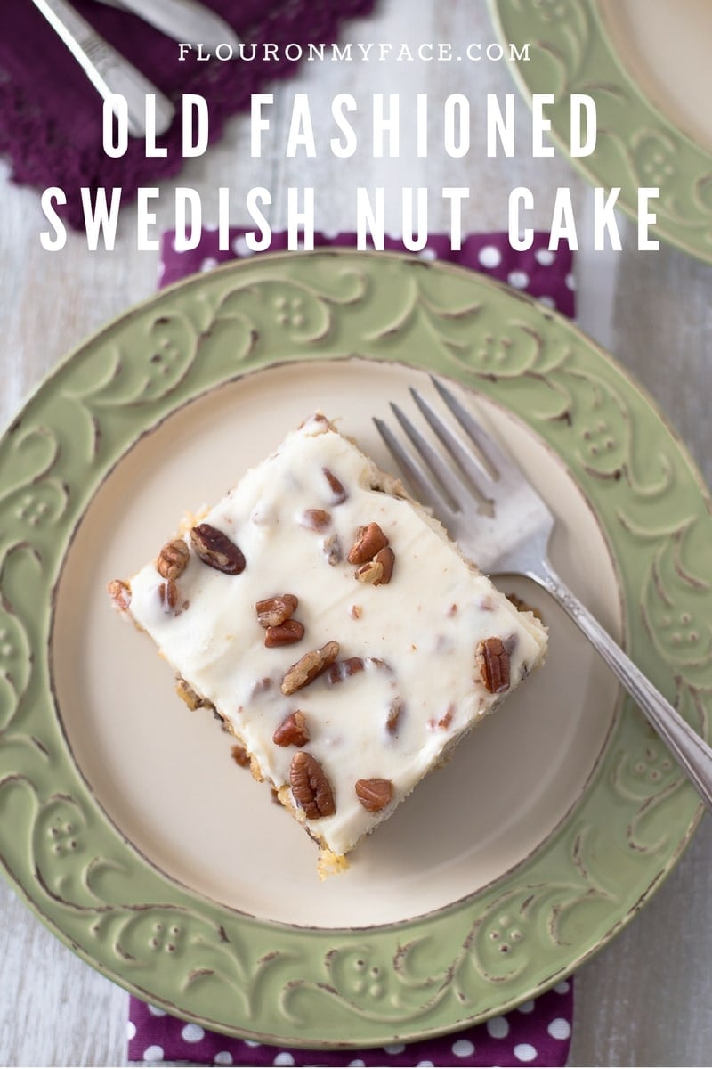 A slice of Old Fashioned Swedish Nut Cake recipe served on a green and cream dessert plate with a purple napkin and a vintage dessert fork.