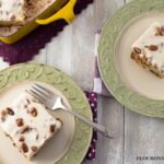 Swedish Nut Cake served in a yellow Dansk 9 xx 13 baking pan and 2 serving plates with vintage silverware.