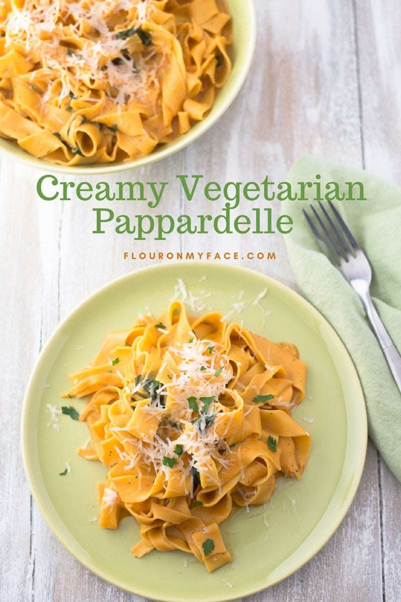 Creamy Vegetarian Pappardelle served on a green vintage dinner plate with shredded Parmesan cheese 