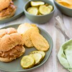 Crock Pot Cheesy Salsa Sloppy Joes recipe on a plate on the table with a green cloth napkin