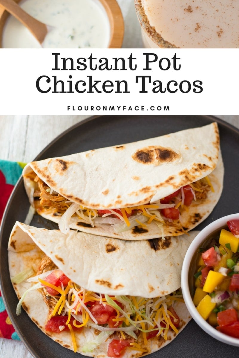 3 ingredient Instant Pot Chicken Tacos served in warm flour tortillas with homemade fresh mango salsa