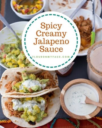 Creamy Jalapeno Sauce in a round wooden bowl served with chicken tacos, mango guacamole and homemade Horchata