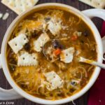 Crock Pot Pumpkin Turkey Chili recipe served with sour cream, shredded cheddar cheese and saltine crackers.