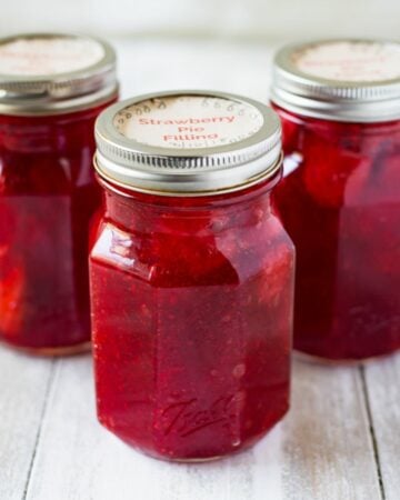 Mason jars filled with homemade strawberry pie filling.