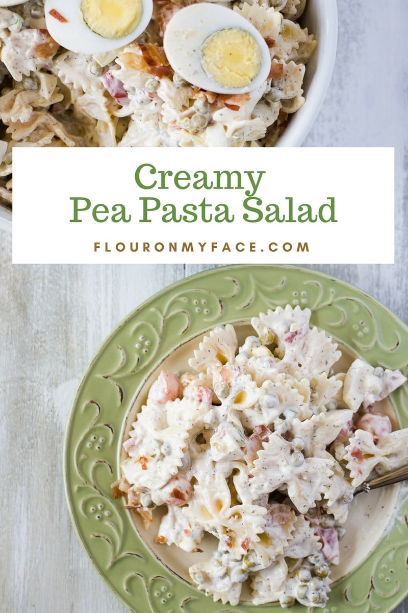 A Creamy Pea and Pasta Salad recipe in a white serving bowl on a plate with green trim
