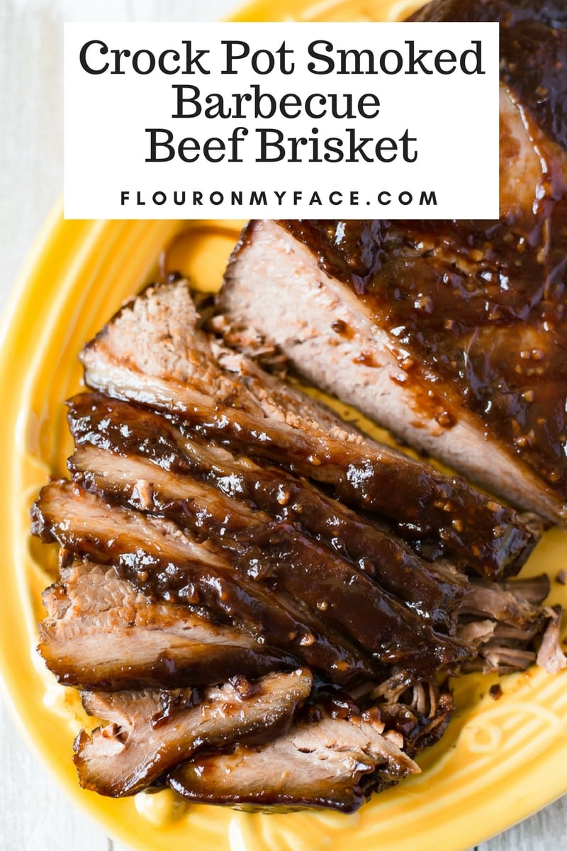 Crock Pot Smoked Barbecue Beef Brisket sliced on a yellow serving platter.