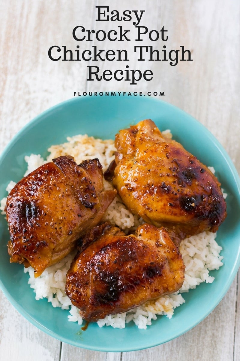 A bowl of Crock Pot Honey Garlic Chicken Thighs served over a bed of cooked white rice.