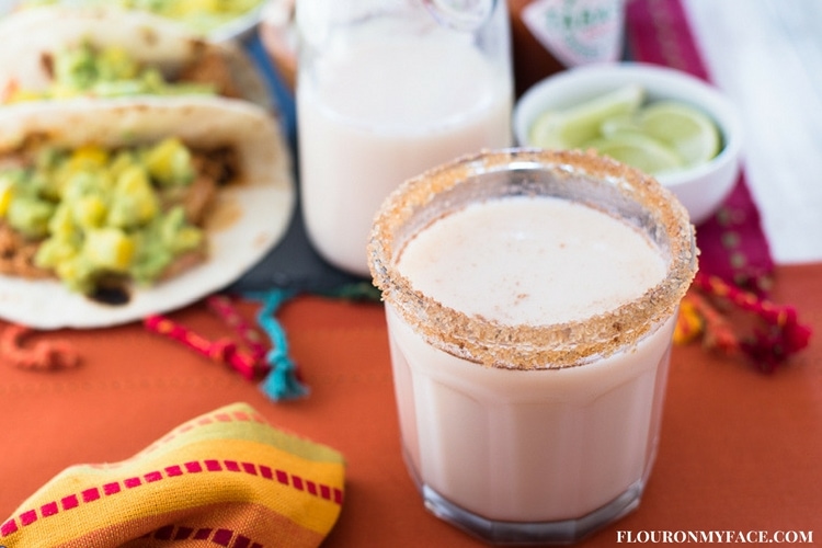 Homemade Horchata recipe served in a glass with a Mexican Food feast.