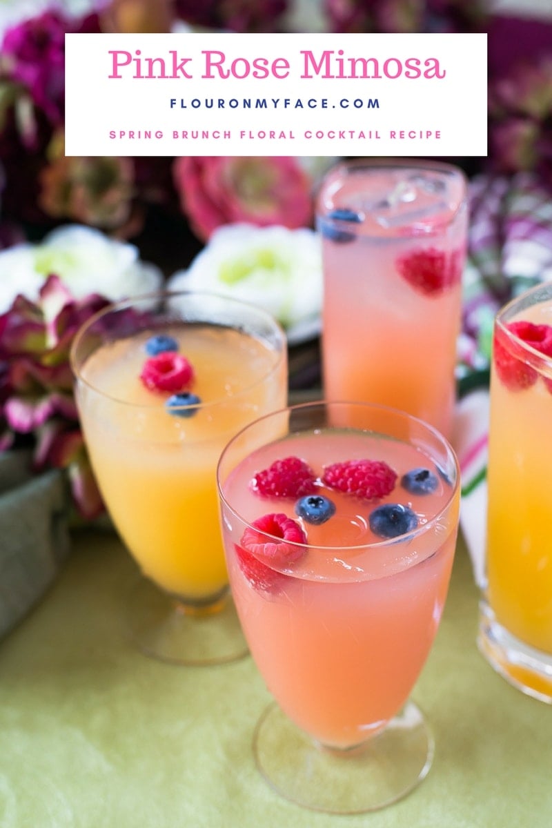 Pink Rose Mimosa recipe made with Torani Rose syrup served in vintage cocktail glasses with raspberry and blueberry garnish for brunch