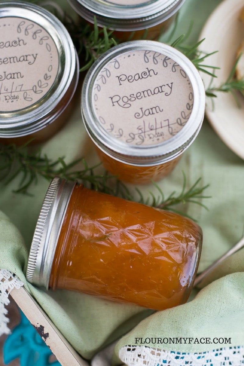 Peach Rosemary Jam on a serving tray in Ball mason jars