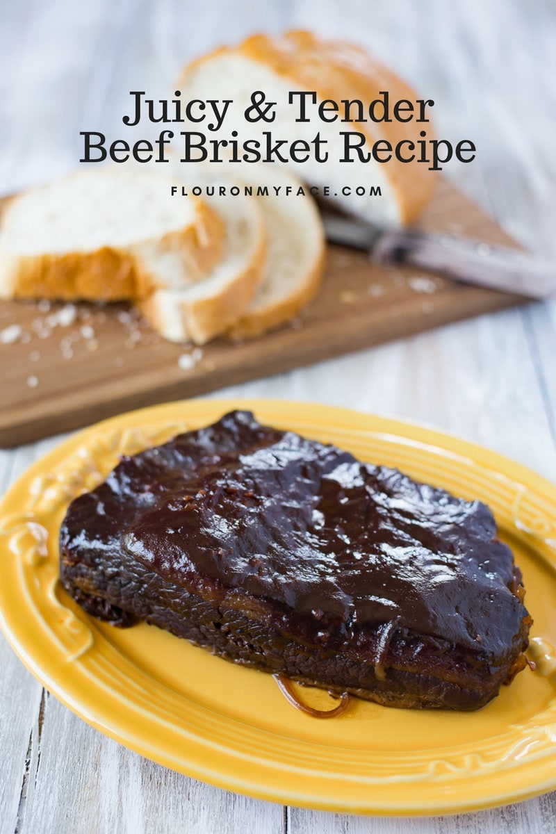 Barbecue Beef Brisket basted with barbecue sauce and served with fresh bread on a cutting board in the background.