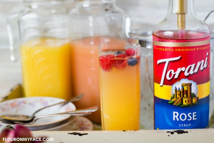 Torani Rose syrup in a serving tray with Pink Rose Mimosas for brunch