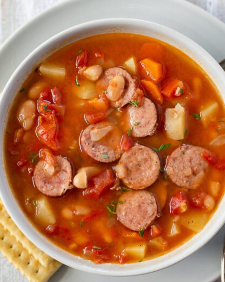 a soup bowl filled with kielbasa soup that was made in the crock pot