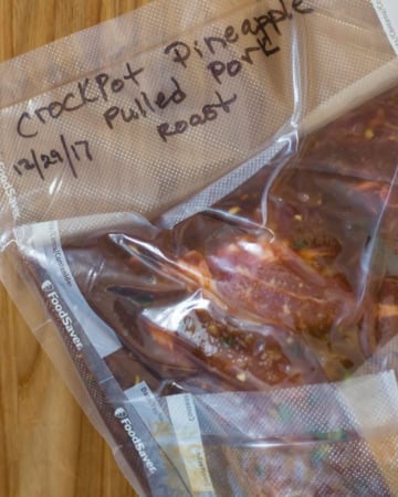 Ingredients forFreezer Pineapple Pulled Pork in a vacuum sealed bag.