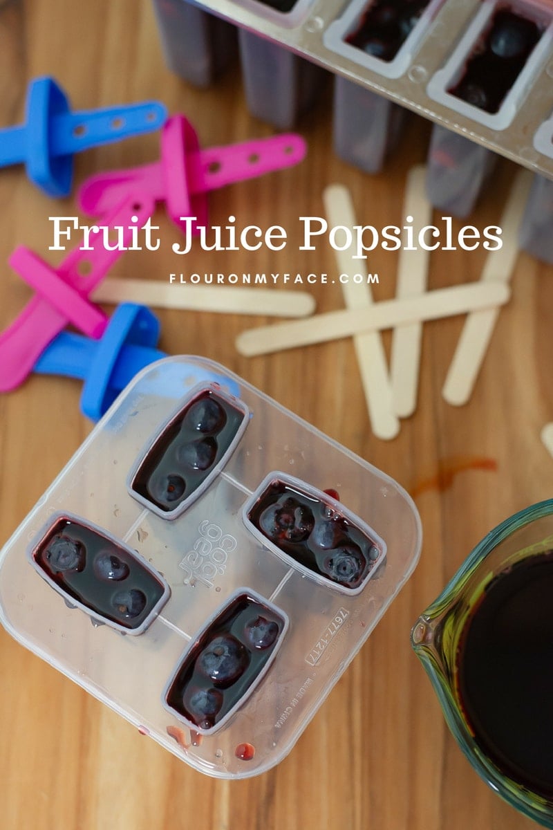 Popsicle Mold filled with real fruit juice and fresh fruit.