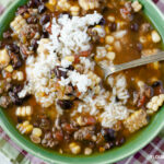 Crock Pot Pork Black Bean Corn recipe made with leftover corn on the cob. Served with a scoop of cooked white rice.