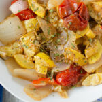 Sauteed summer squash, onions, bell peppers and heirloom cherry tomatoes served in a white serving bowl