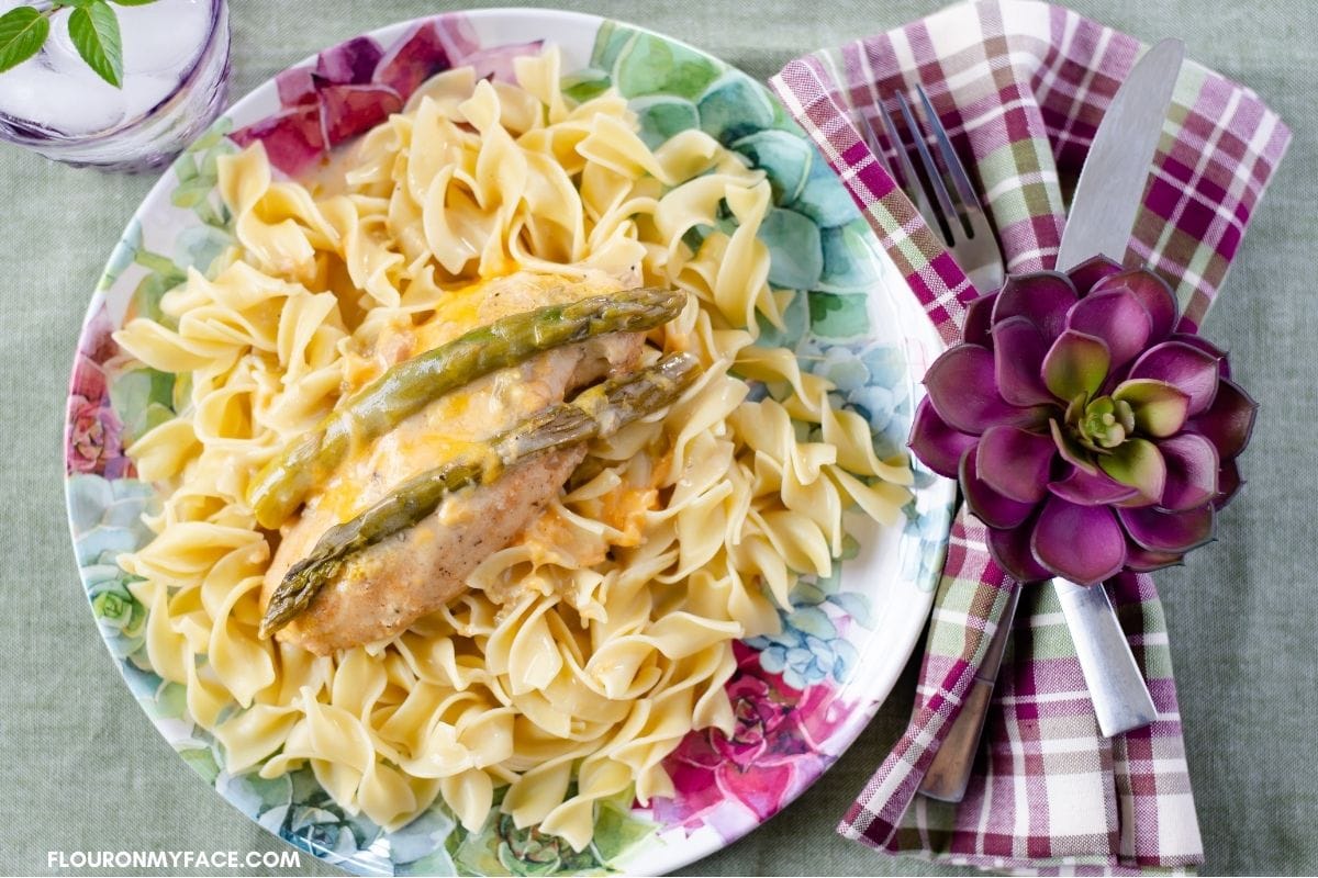 Cheesy chicken asparagus on noodles.