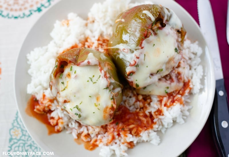 stuffed bell peppers over a bed of rice.