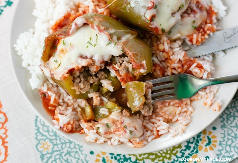 Crock Pot Stuffed Sweet Bell Peppers served over a bed of white rice