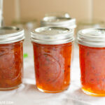 Canning jars filled with freshly made Spicy Peach Lime Chutney.