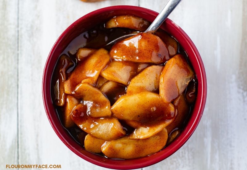 Instant Pot Cinnamon Apples recipe with a thick brown sugar glaze in a serving bowl.