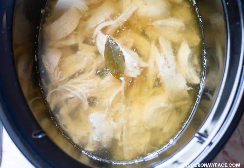 Shredded and cooked boneless chicken breasts in the crock pot for Chicken Sweet Potato Soup