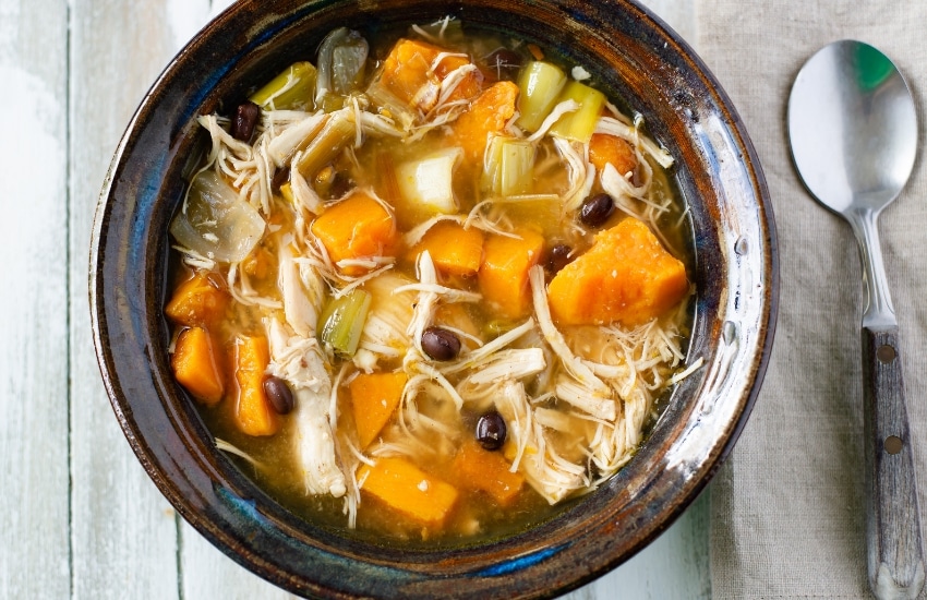 A bowl of Crock Pot Chicken and roasted vegetable soup 