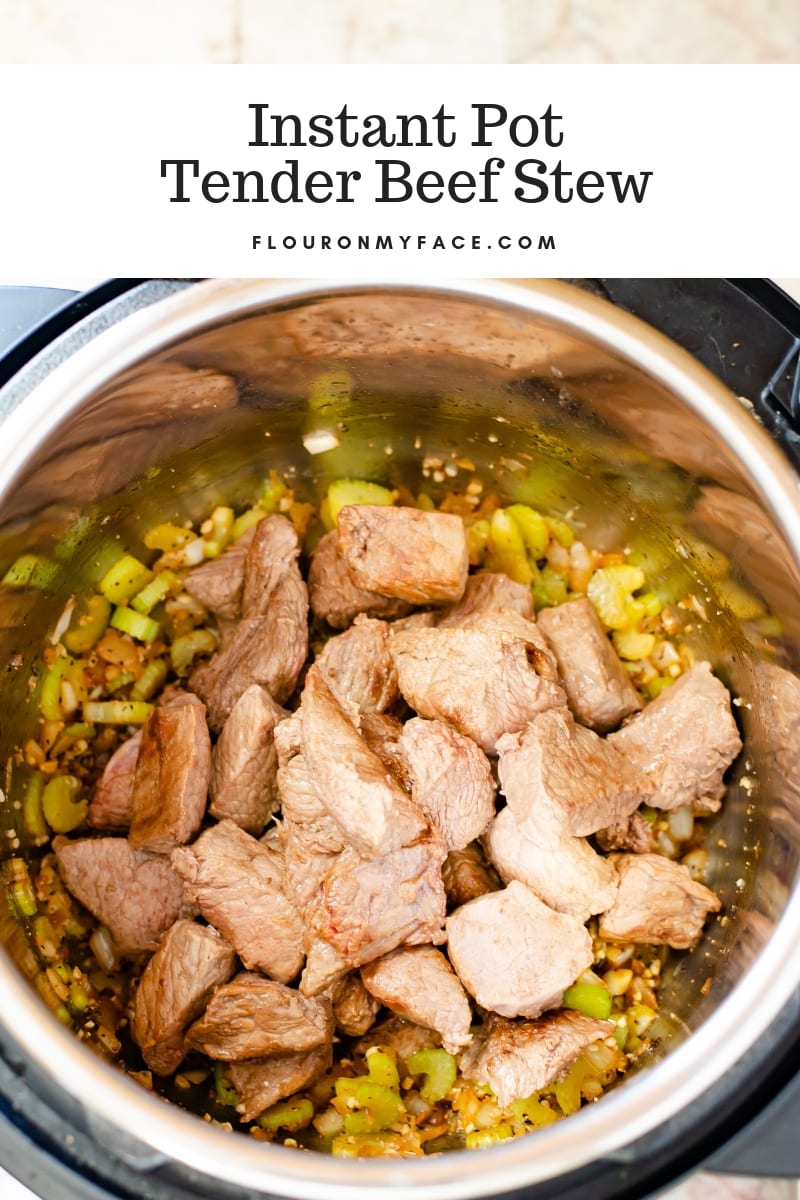 Making Instant Pot Beef Stew with the stew meat and vegetables browning inside the instant pot.