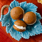 Teal blue fall leaf shaped serving platter with 3 pumpkin spice whoopie pies