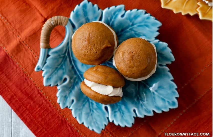 Teal blue fall leaf shaped serving platter with 3 pumpkin spice whoopie pies