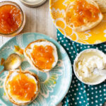 Homemade marmalade on cream cheese and toasted English muffins
