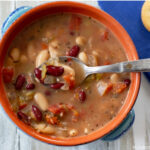 A bowl and spoon with Crock Pot Spicy Bean Soup recipe