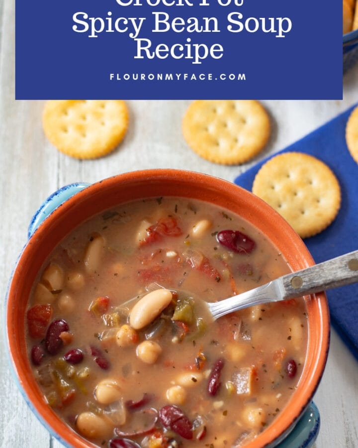 Crock Pot Spicy Bean Soup served in a blue terra cotta bowl with crackers.
